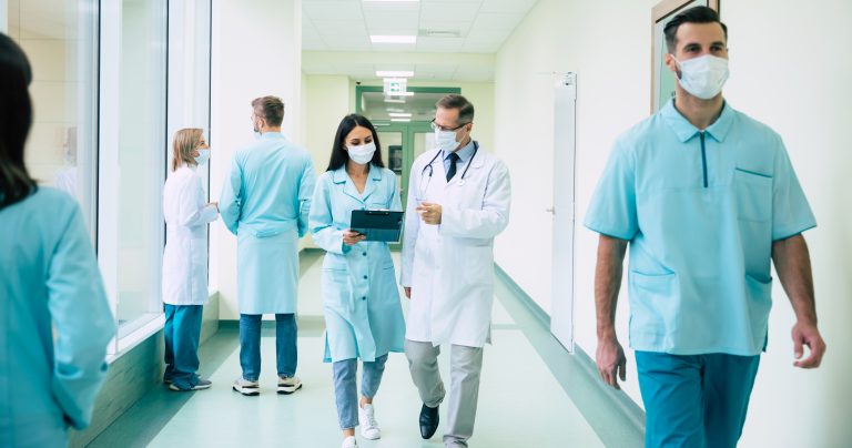 Two,Confident,Doctors,In,Safety,Medical,Masks,Have,A,Discussion